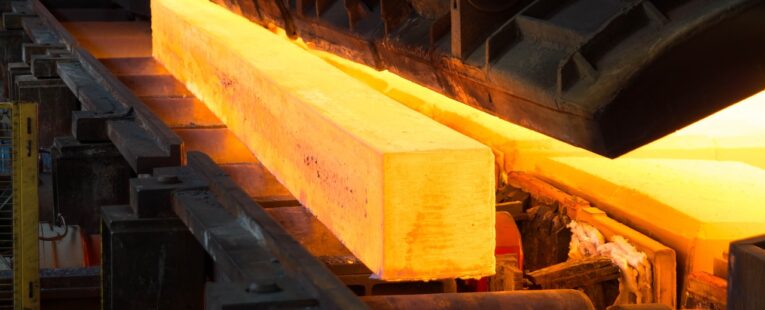 close up of a steel rolling mill with a rail track