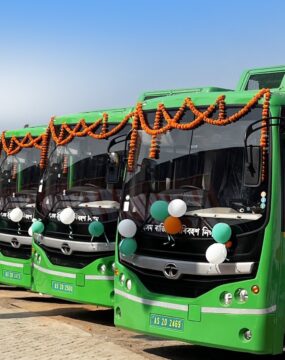 A fleet of green coloured electric buses in Guwahati, India